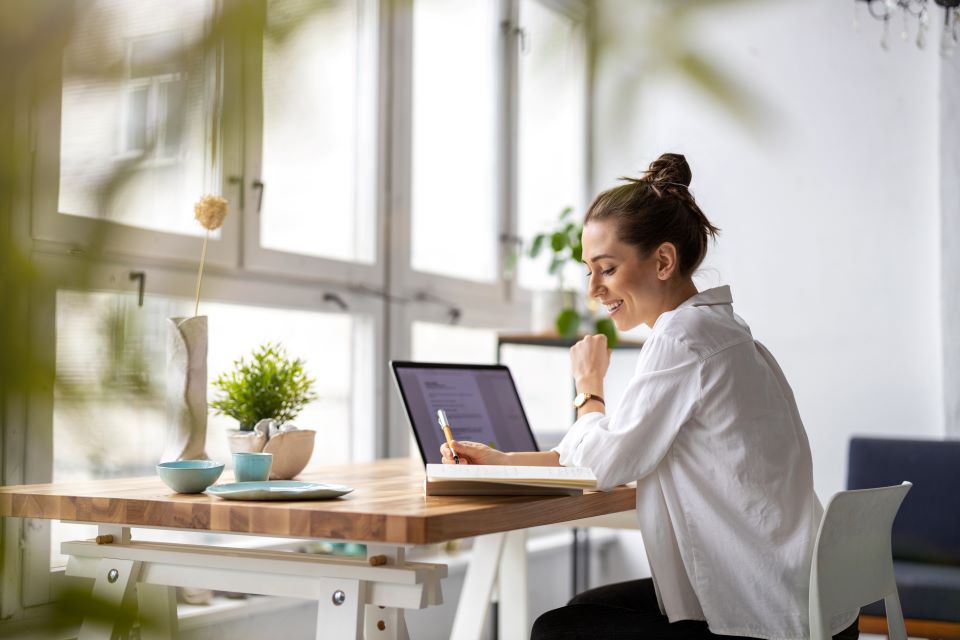 Woman writing with pen in hand 