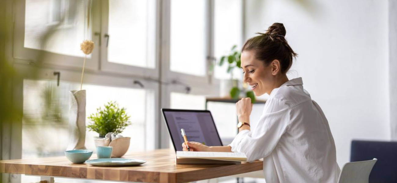 Woman writing with pen in hand 